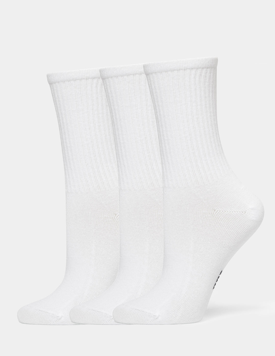 Three pairs of white crew socks arranged side by side on a light gray background.