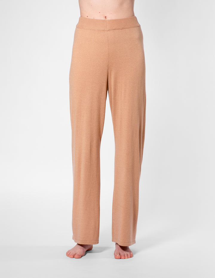 Tan pants worn by a person on a white background