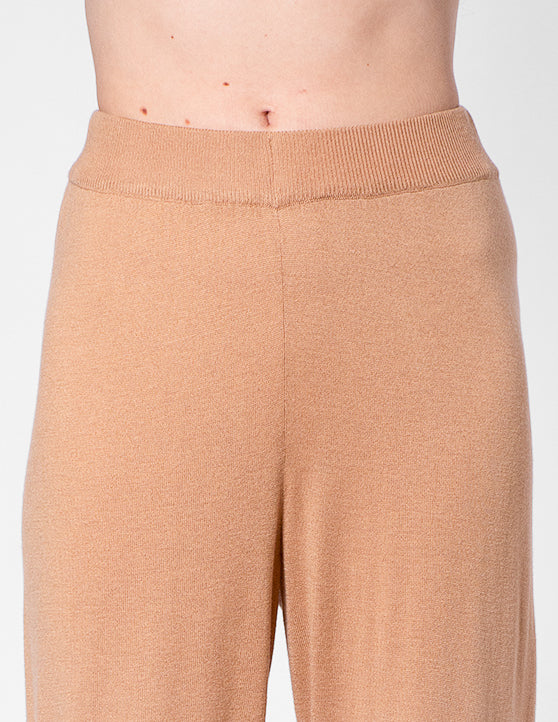Tan pants close-up worn by a person on a white background