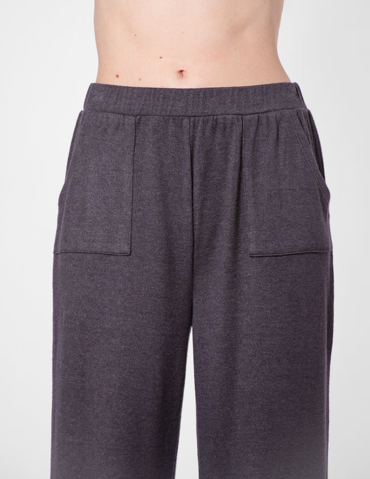Dark gray sweatpants close-up on a plain background