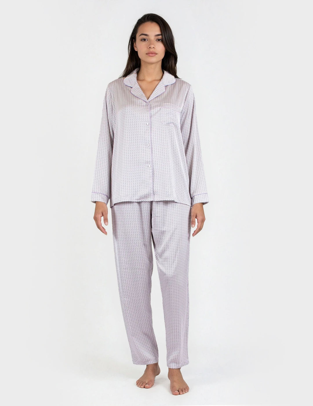 Woman wearing a checkered pajama set on a white background