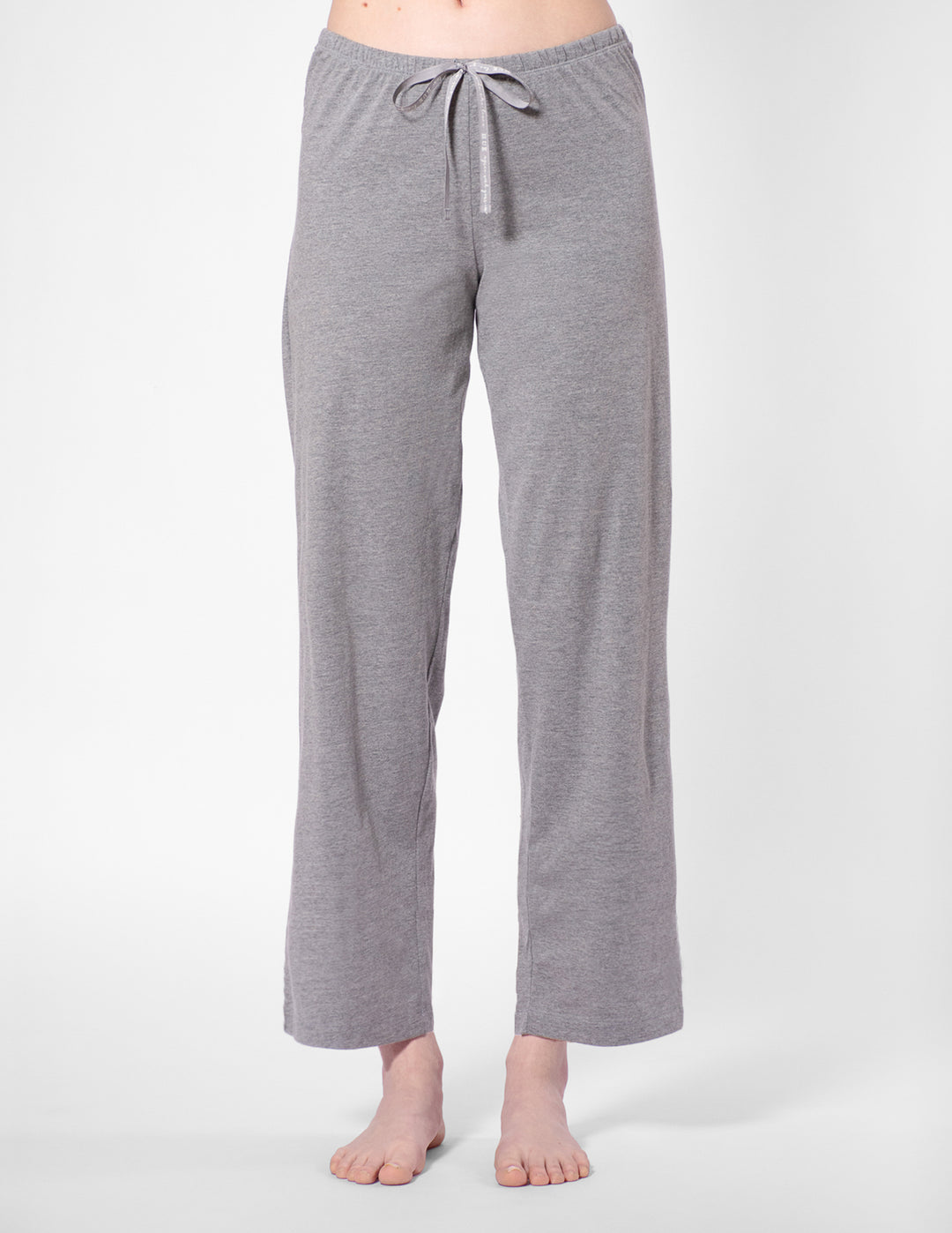 Gray pajama pants worn by a person on a white background