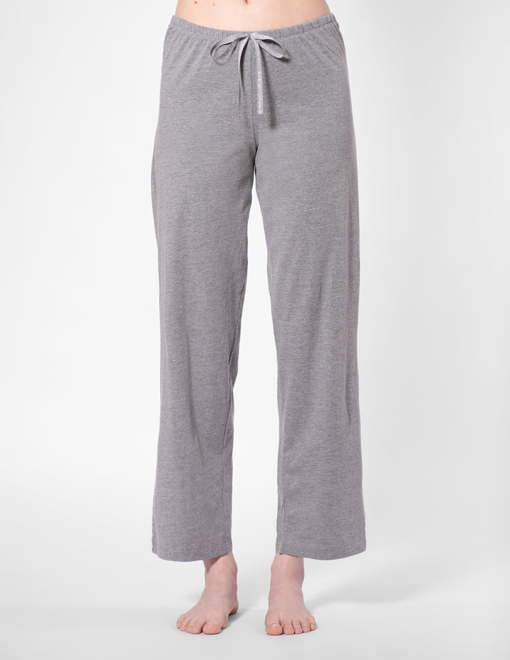 Gray pajama pants worn by a person on a white background