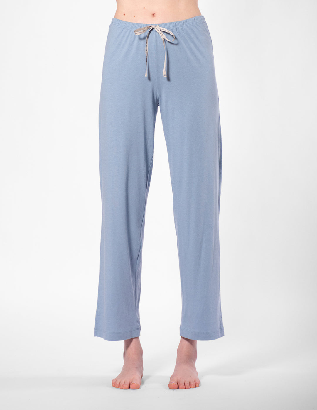 Light blue pajama pants with a drawstring on a white background
