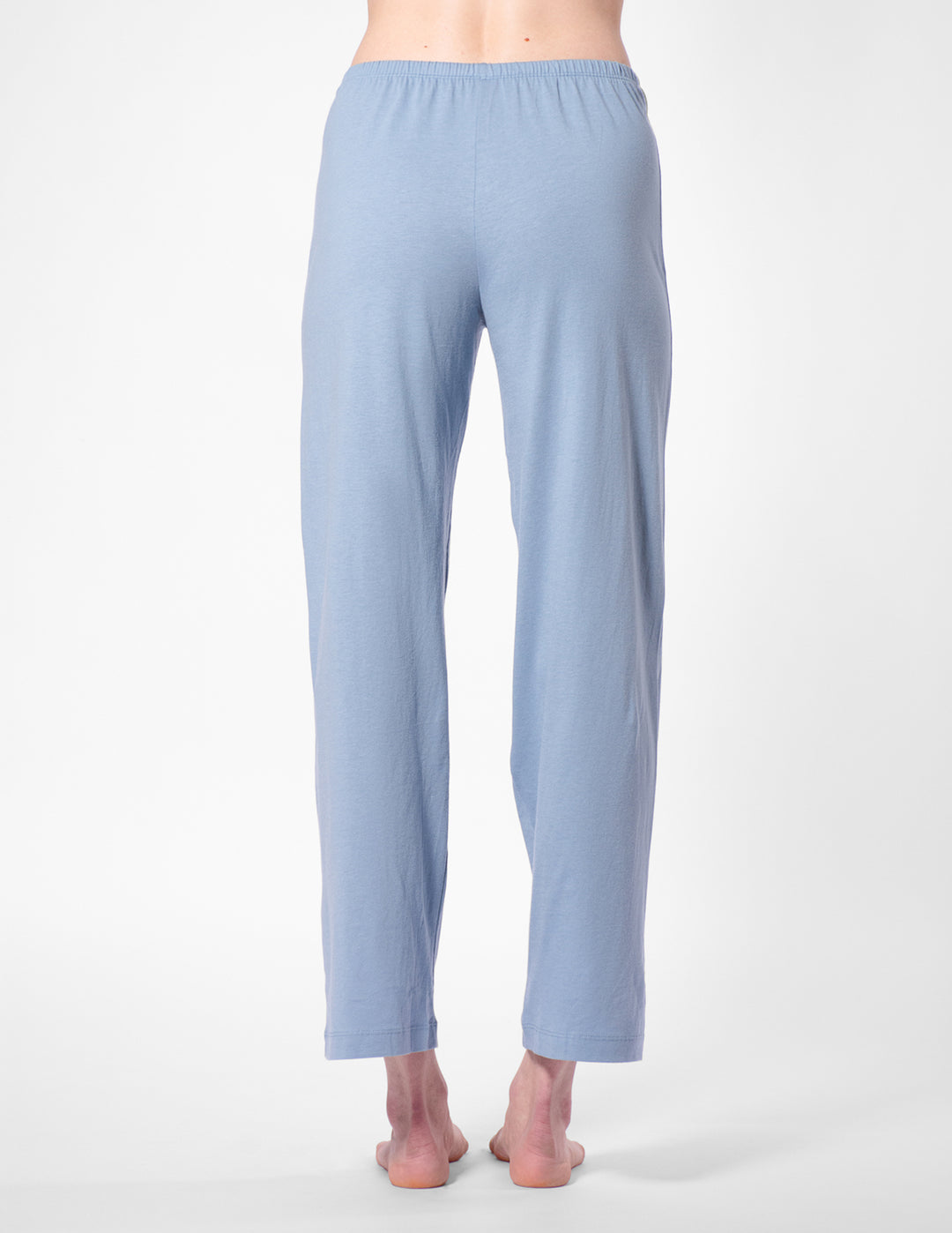 Light blue pajama pants worn by a person on a white background