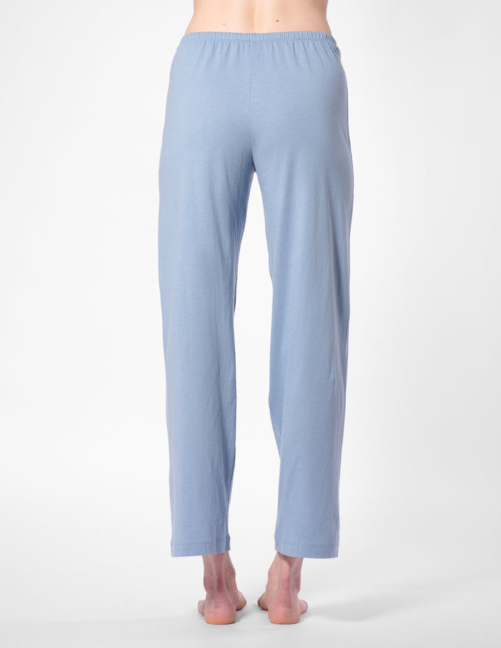 Light blue pajama pants worn by a person on a white background