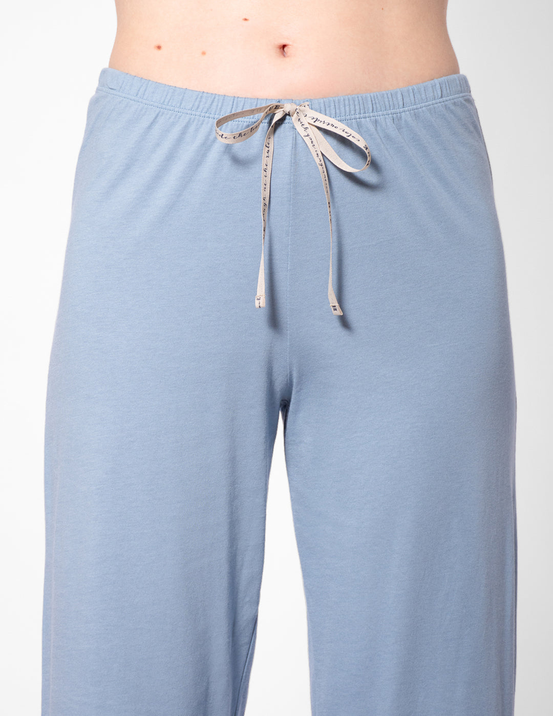 Light blue pajama pants with a drawstring on a white background
