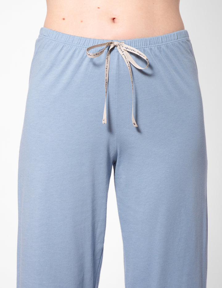 Light blue pajama pants with a drawstring on a white background