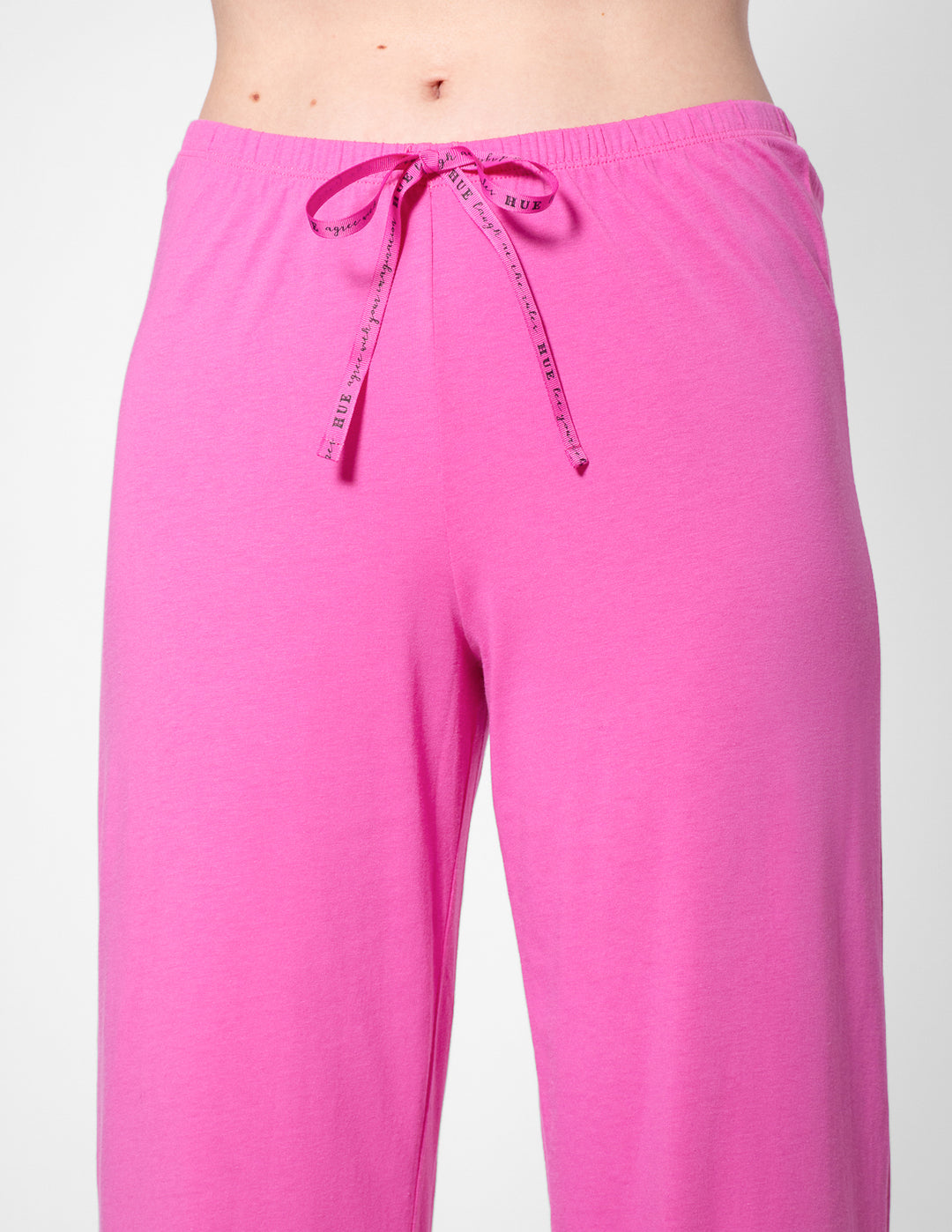 Pink pajama pants with a drawstring on a white background