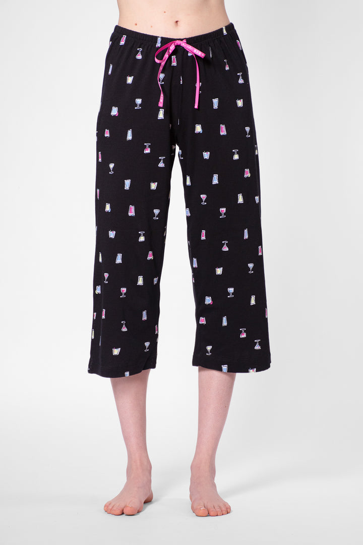 Black capri pajama pants with colorful pattern on a white background