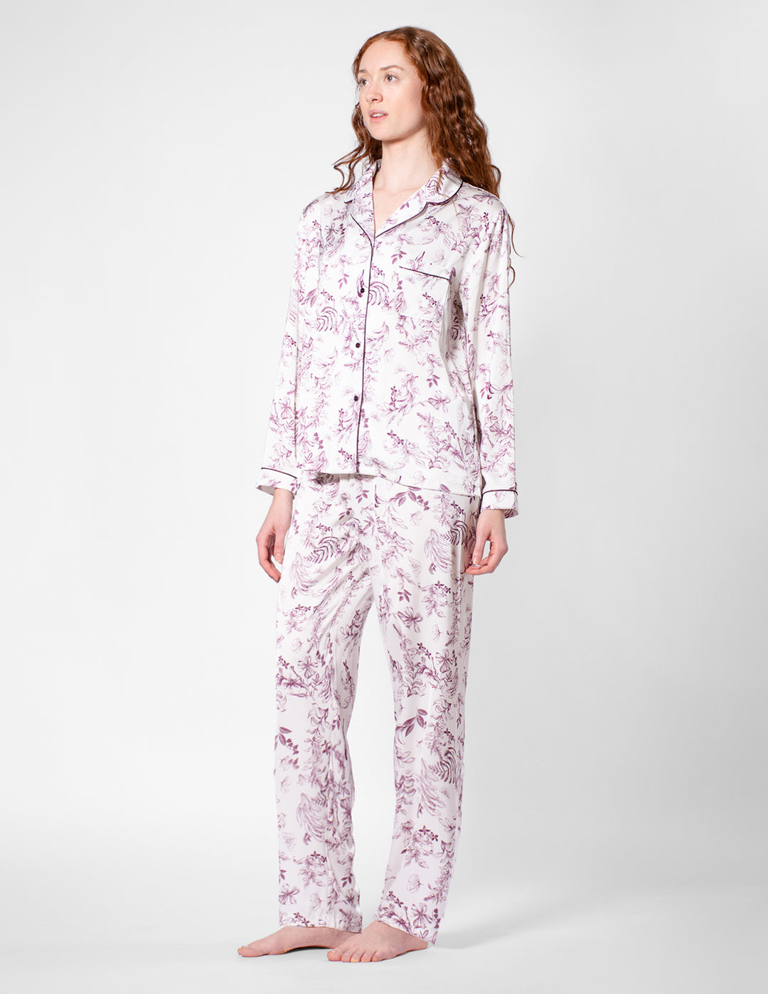 Woman wearing a floral pajama set on a white background