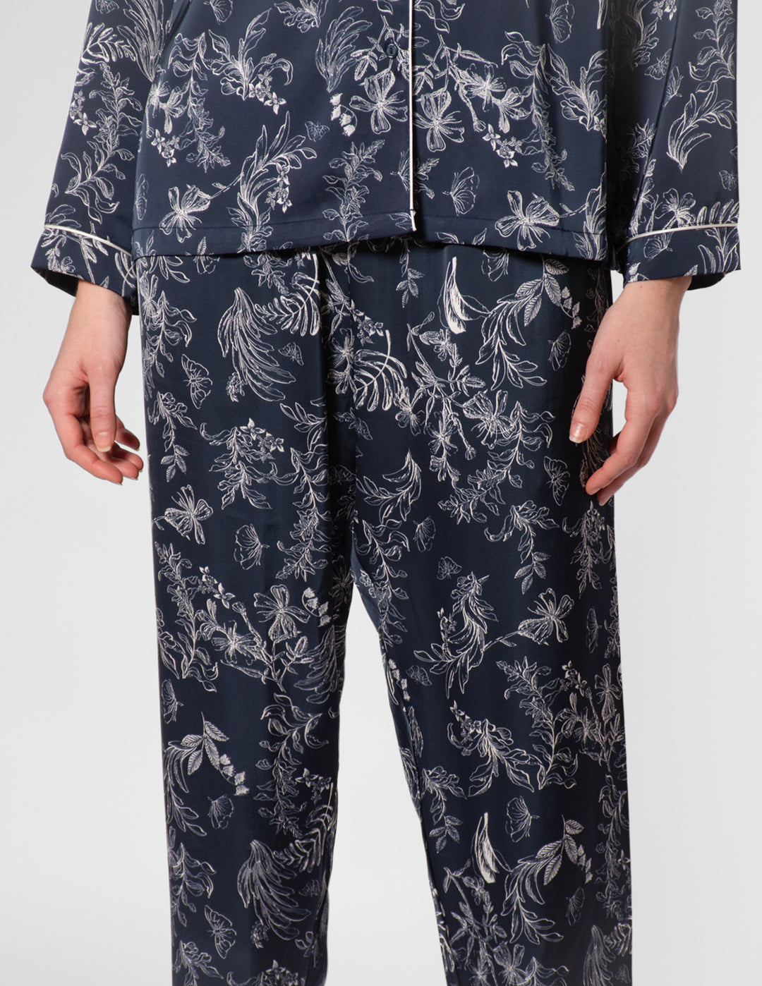 Navy pajama set with white floral pattern on a white background