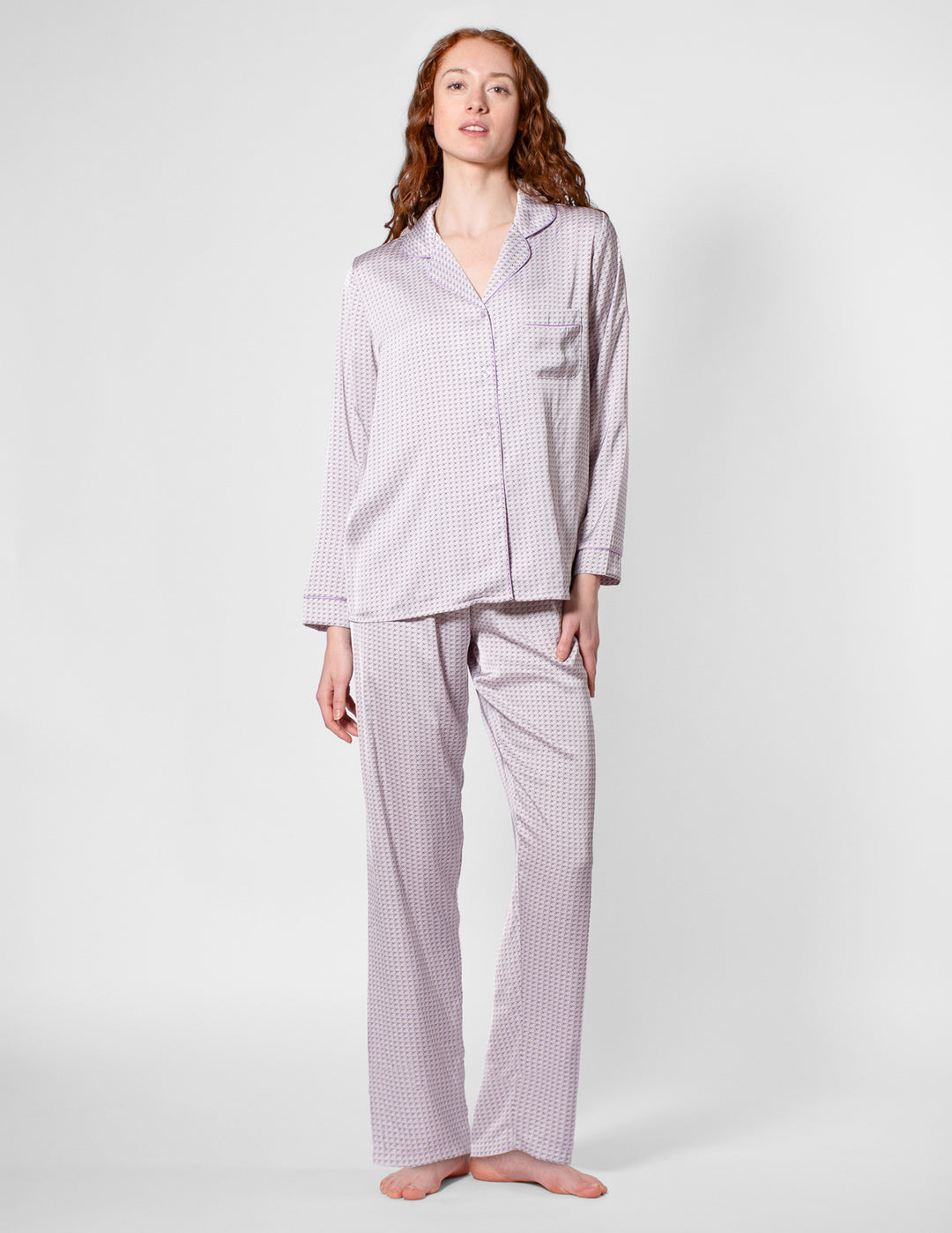 Woman wearing a checkered pajama set on a white background