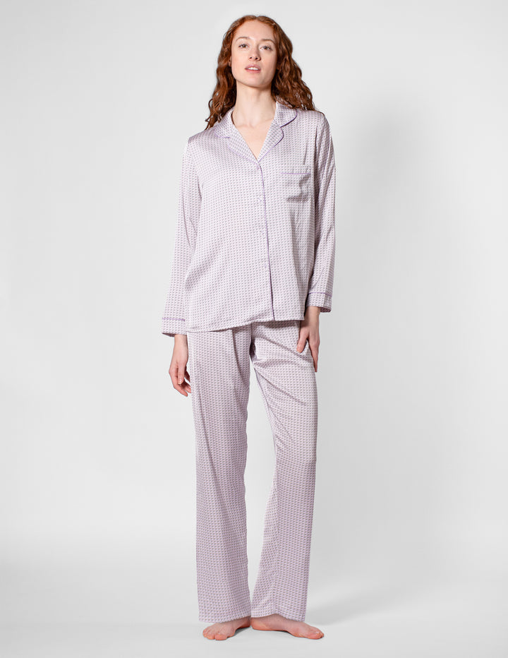 Woman wearing a checkered pajama set on a white background