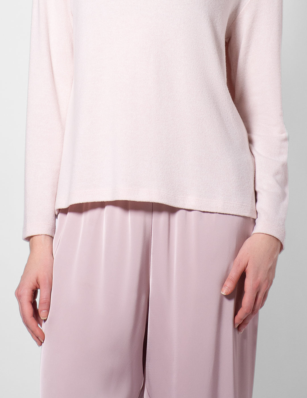 Light pink long-sleeve top and wide-leg pants on a plain background
