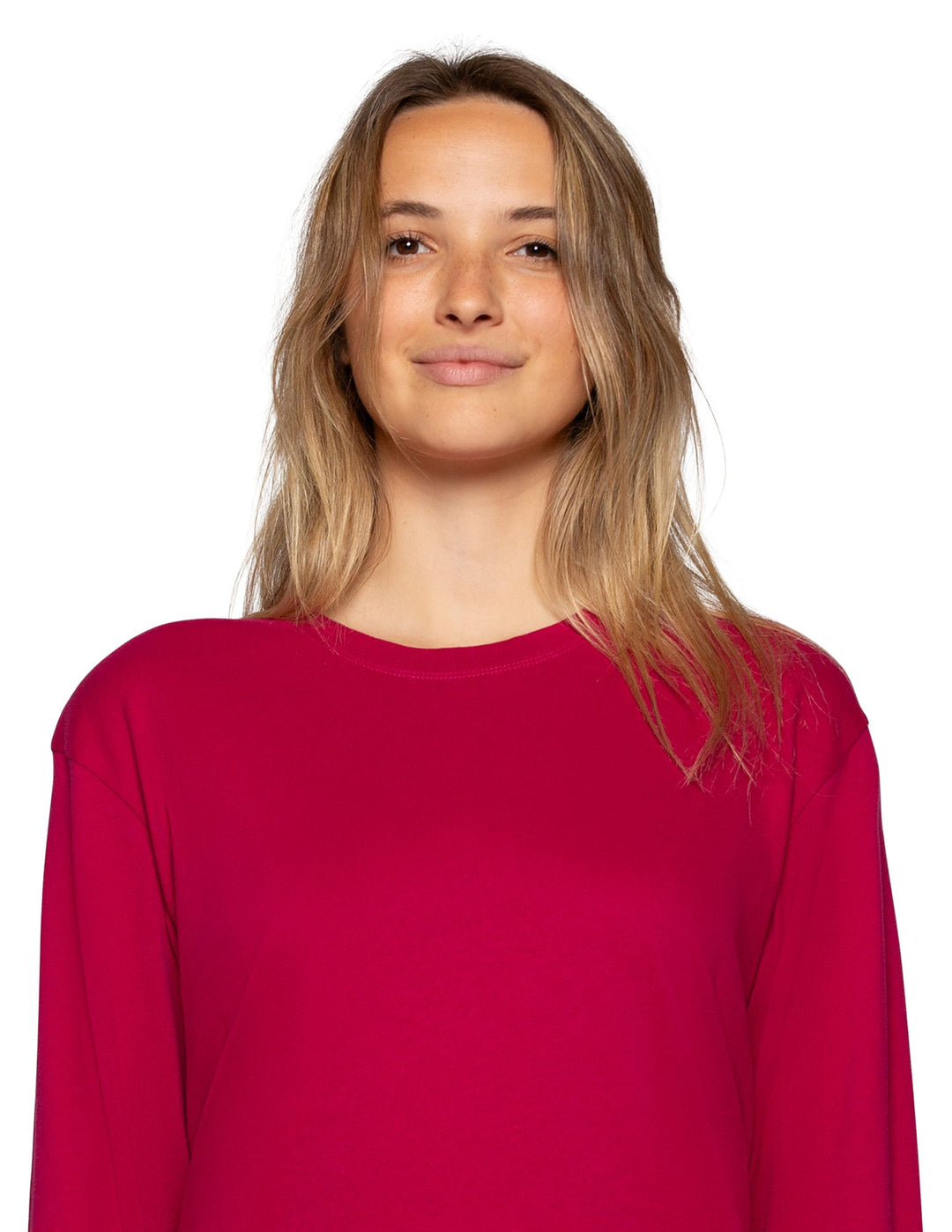 A woman with blonde hair wearing a bright magenta long-sleeve crewneck top, photographed against a solid white background.