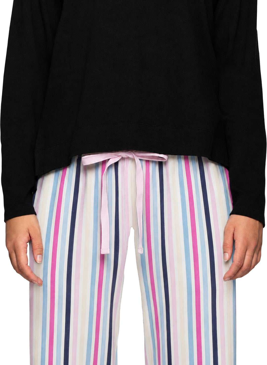 A person wearing striped lounge pants with vertical pink, navy, light blue, and white stripes, paired with a black top. The pants have a light pink drawstring tie at the waist.