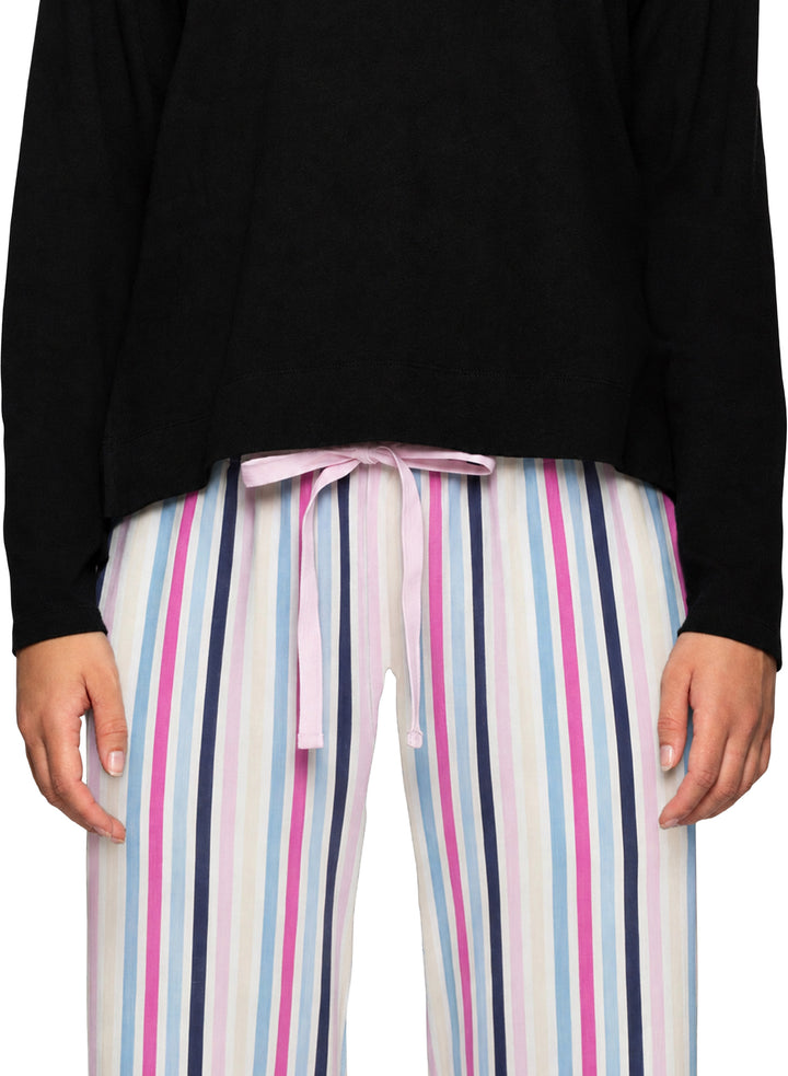 A person wearing striped lounge pants with vertical pink, navy, light blue, and white stripes, paired with a black top. The pants have a light pink drawstring tie at the waist.