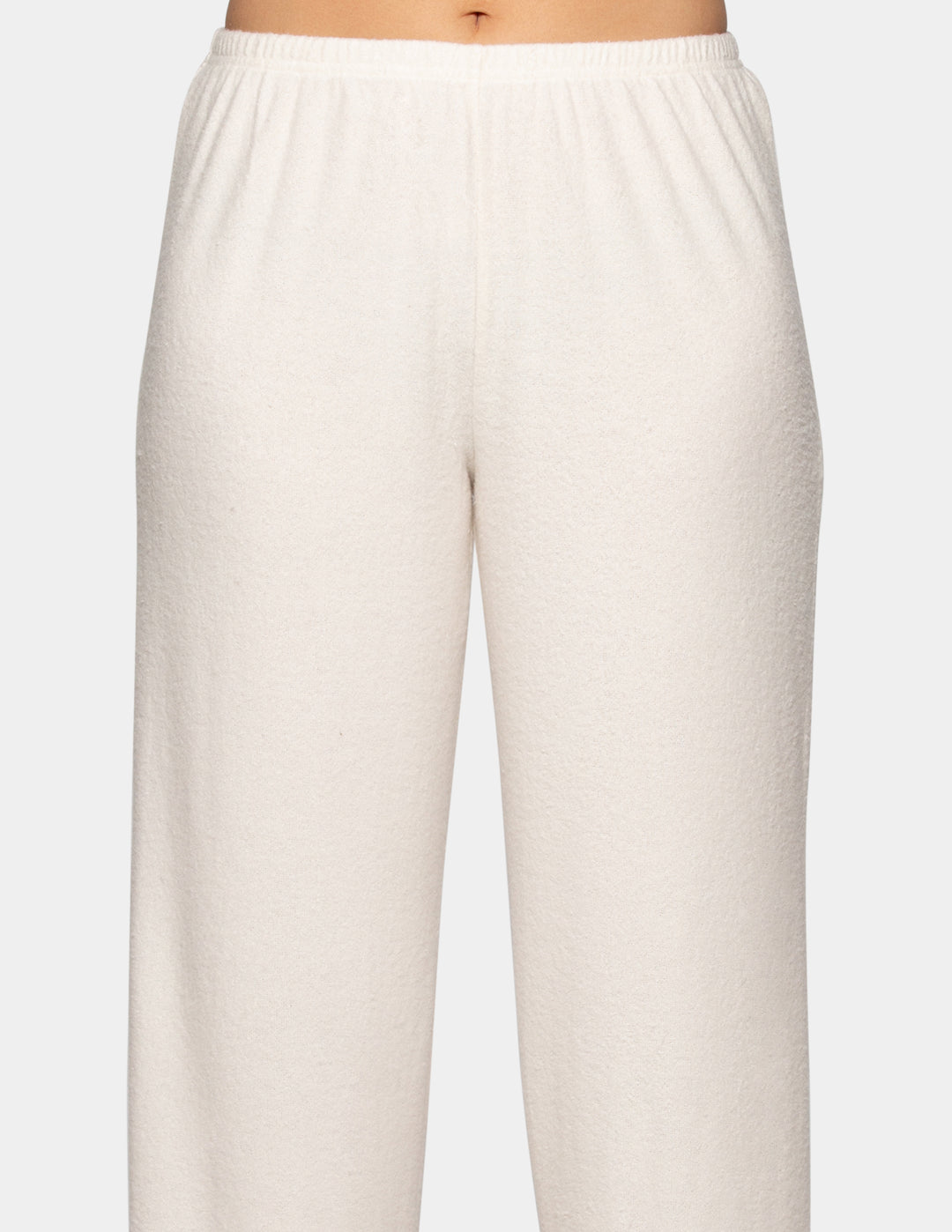 A model wearing a pair of off-white pajama pants.