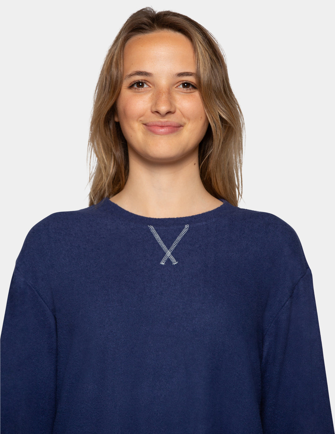 A model wearing a navy long sleeve pajama shirt.