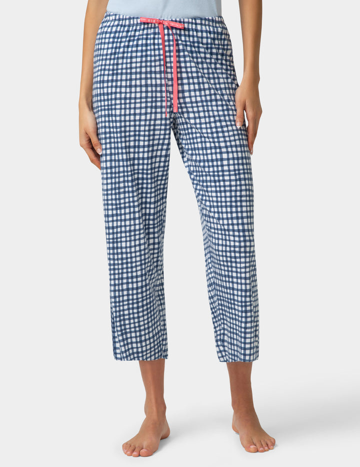 Person wearing gingham PJ capri in blue and white check pattern