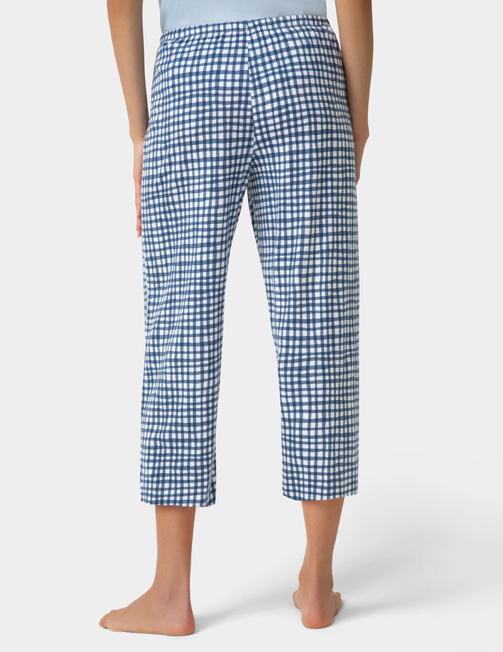 Person wearing gingham PJ capri in blue and white check pattern