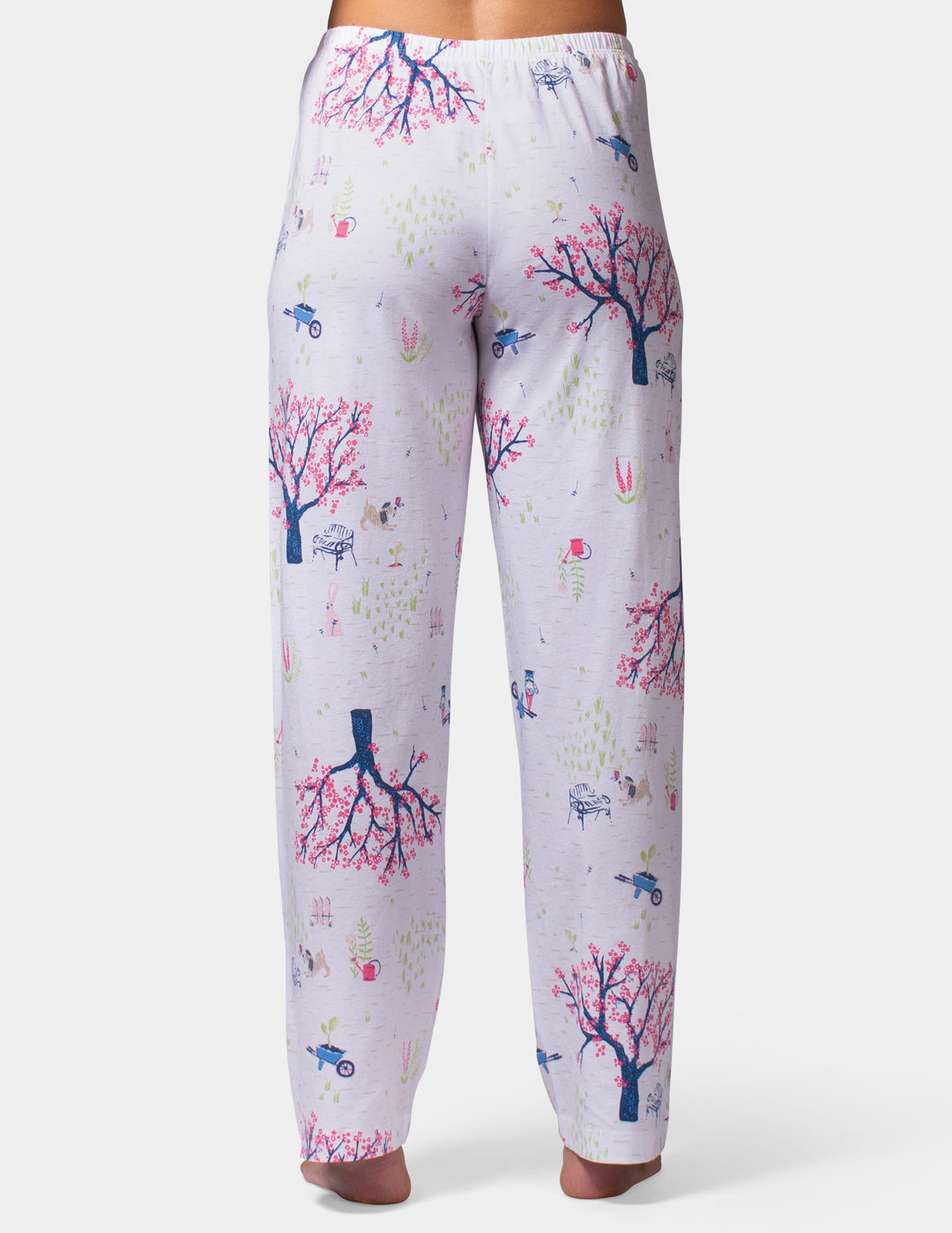 White pajama pants with colorful nature-themed print on a white background