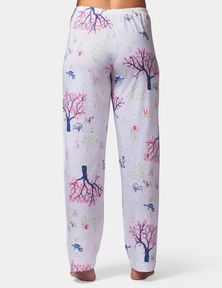 White pajama pants with colorful nature-themed print on a white background