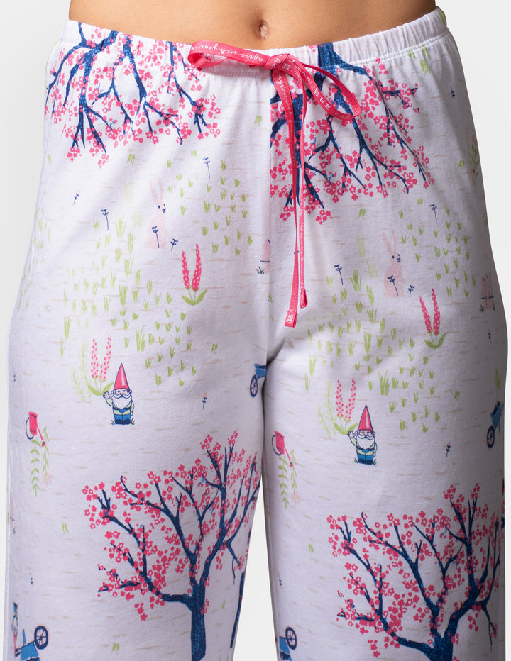 Pajama pants with a colorful gnome and tree pattern on a white background