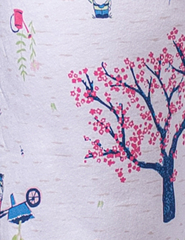 Close-up of a fabric with a tree and people pattern on a white background