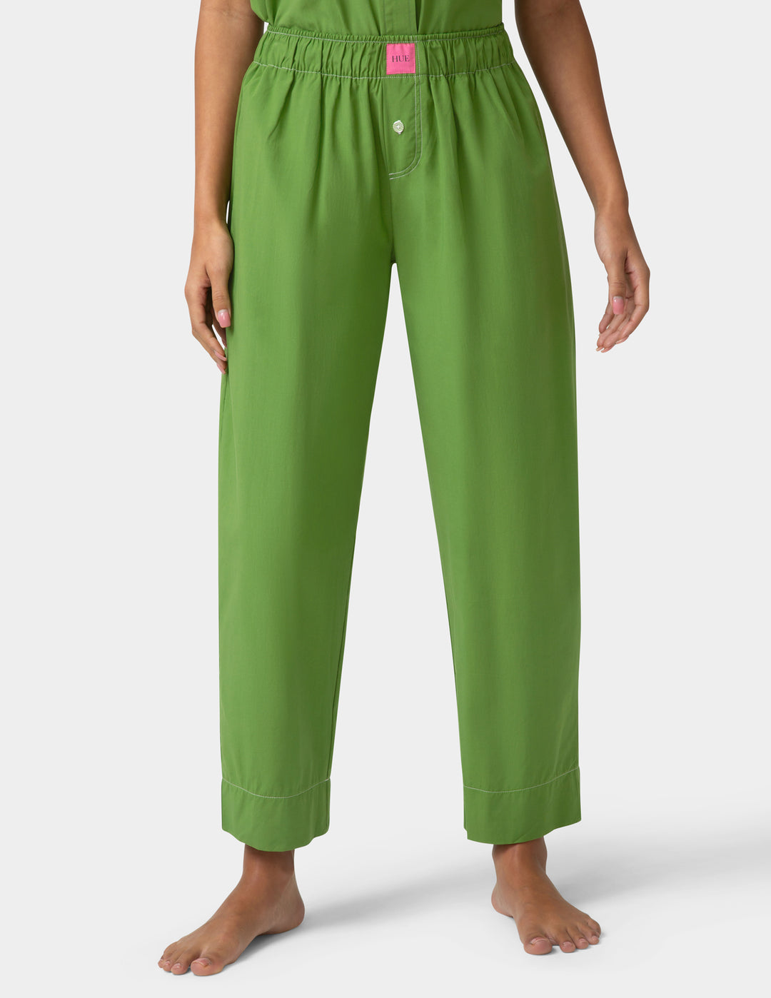 Person wearing green pajama pants