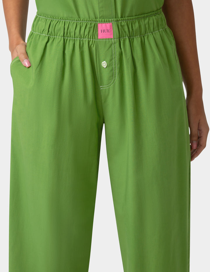 Green pajama pants with a pink label on a white background