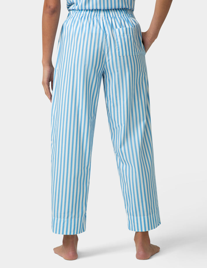 Person wearing blue and white striped pants on a white background