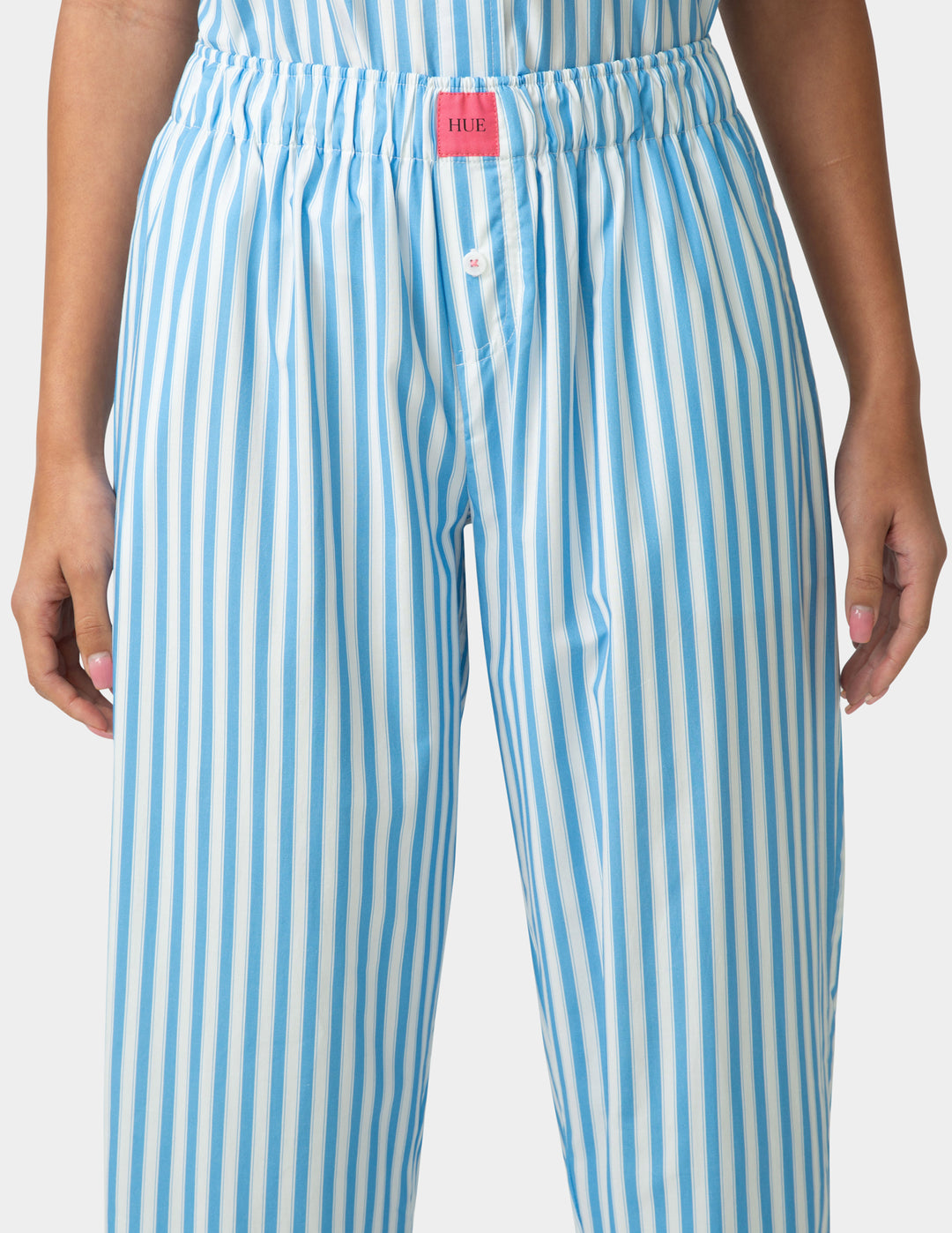 Blue and white striped pants with a visible brand label on a plain background