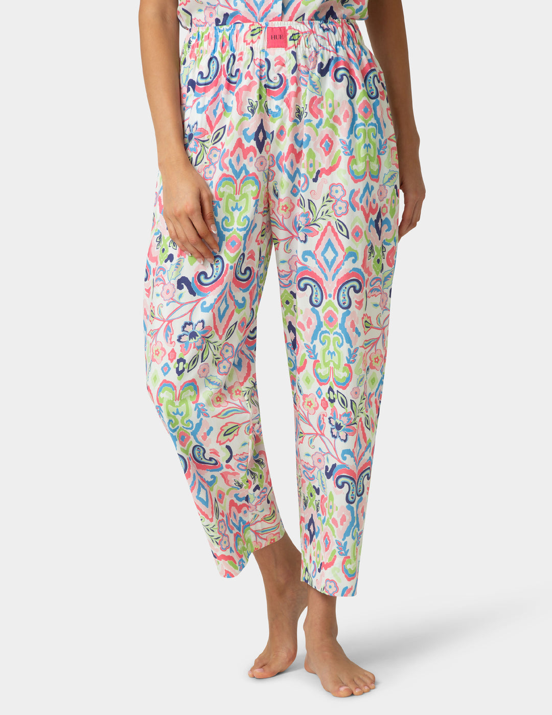 Colorful patterned pants worn by a person on a white background