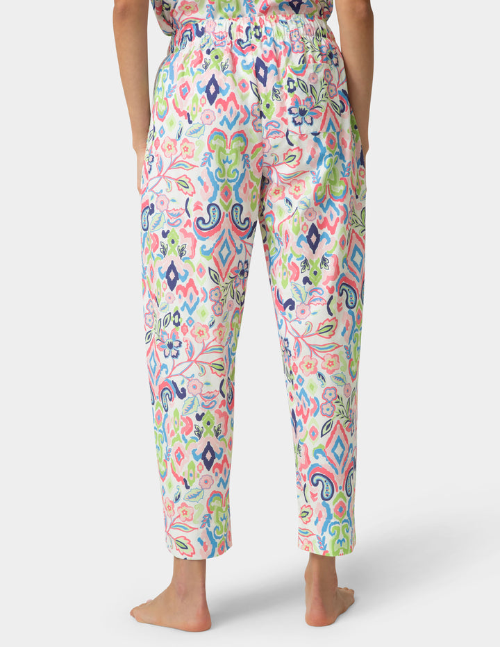 Colorful patterned pants worn by a person on a white background