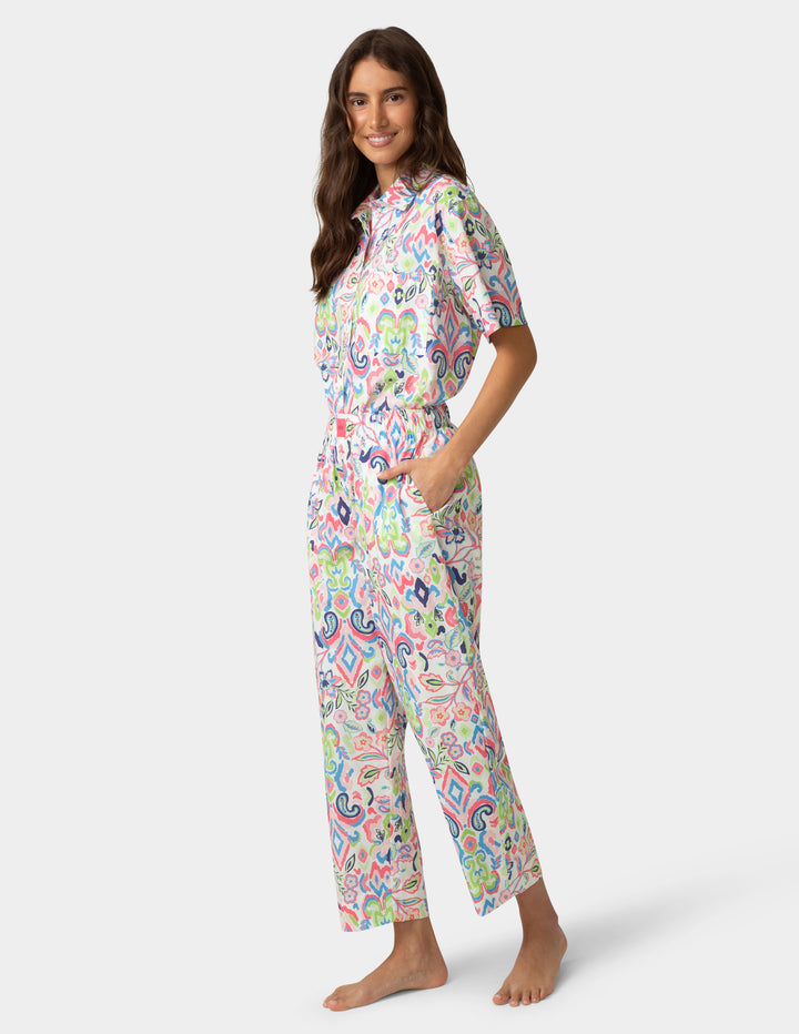 Woman wearing a colorful pajama set on a white background