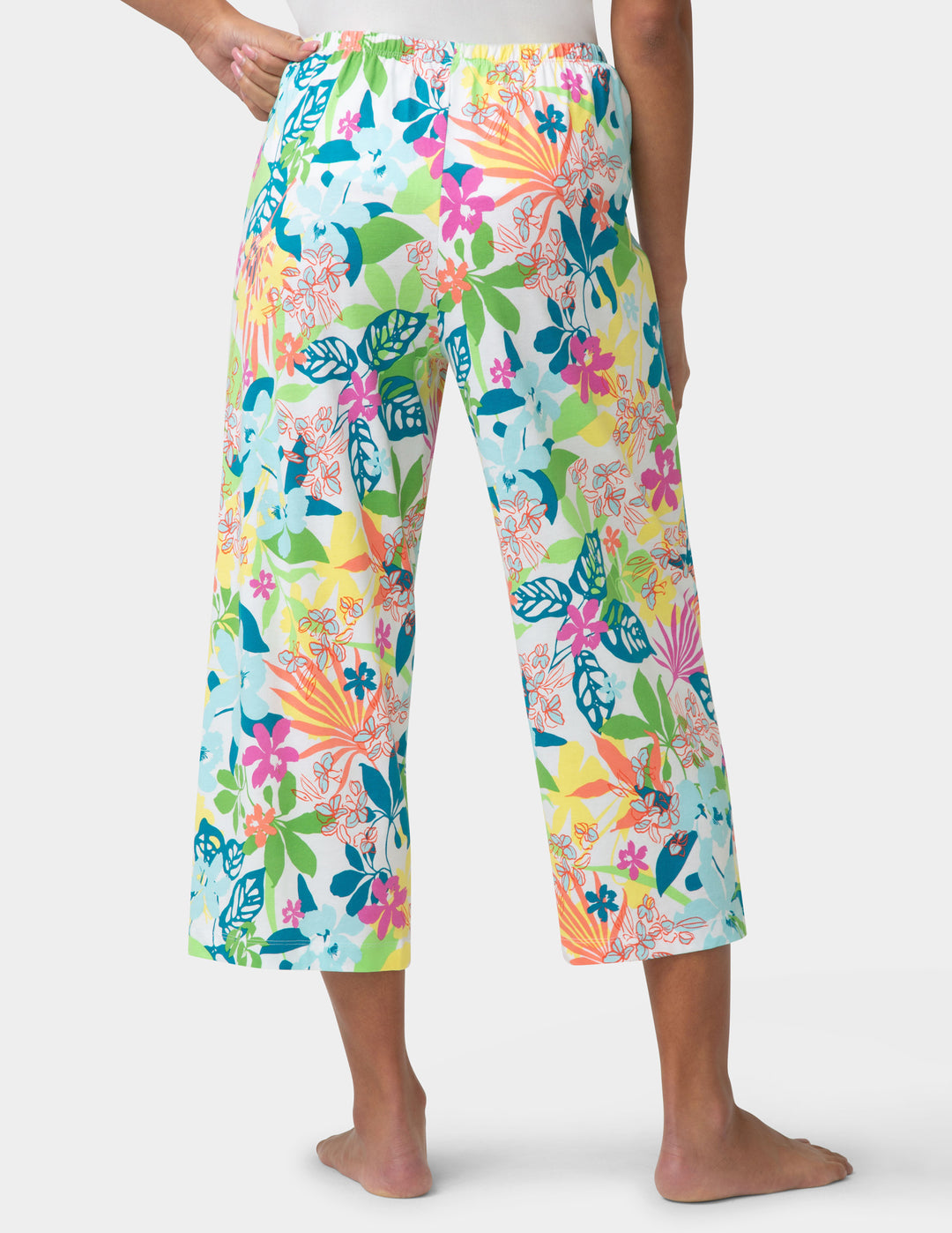 Colorful tropical print pj pants worn by a person on a white background