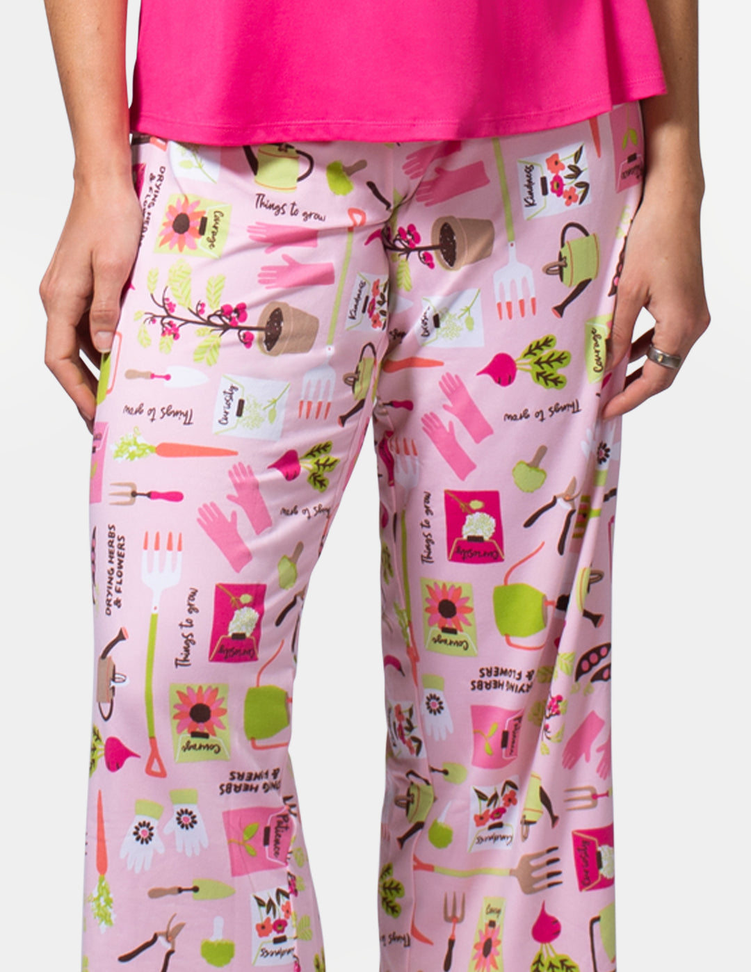 Pink pants with colorful pattern worn by a person, on a white background