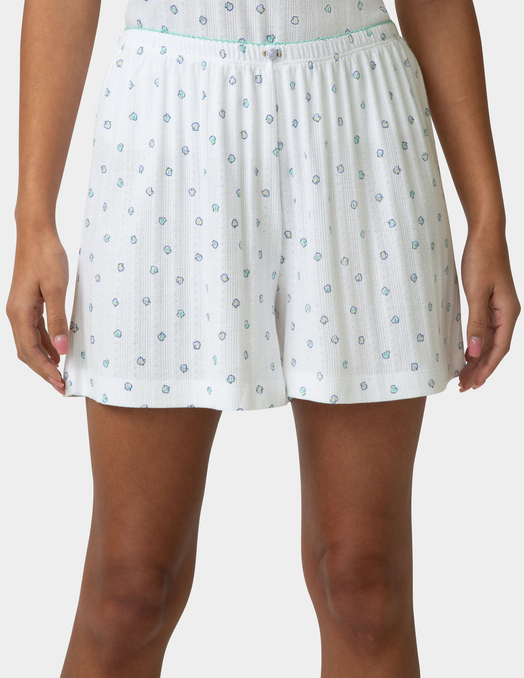 White pointelle PJ boxers detailed view being worn by a woman on a white a background 
