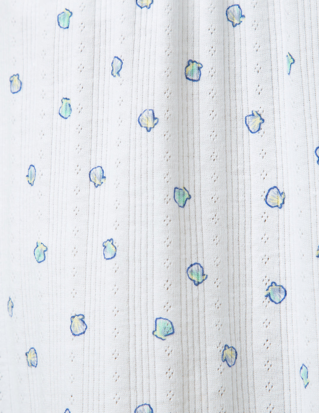 White fabric with small colorful shell patterns