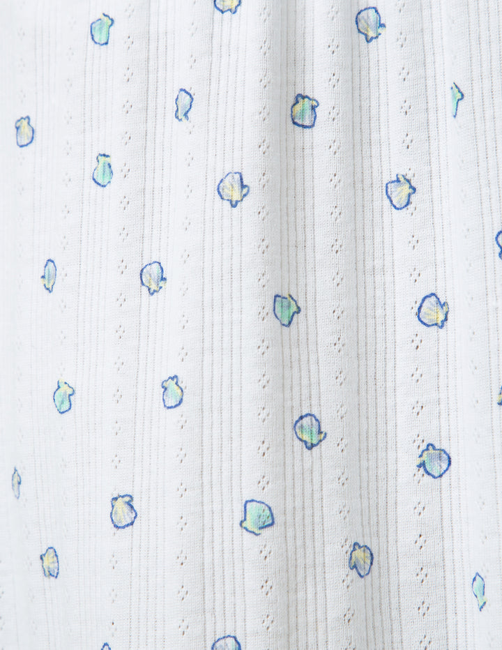 White fabric with small colorful shell patterns