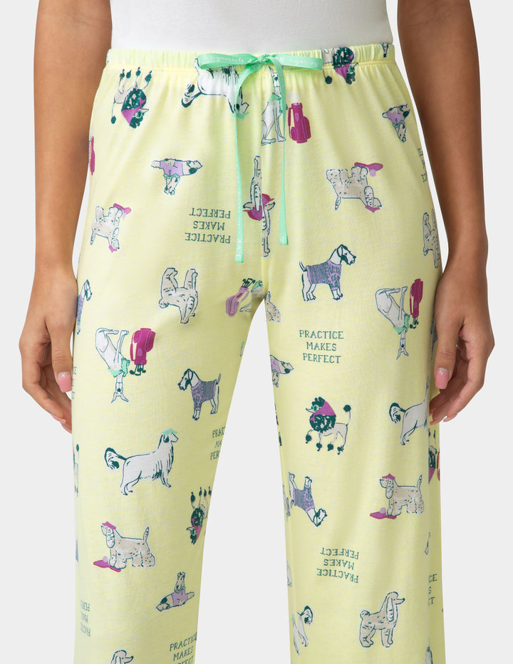 Light yellow pajama pants with dog illustrations on a white background