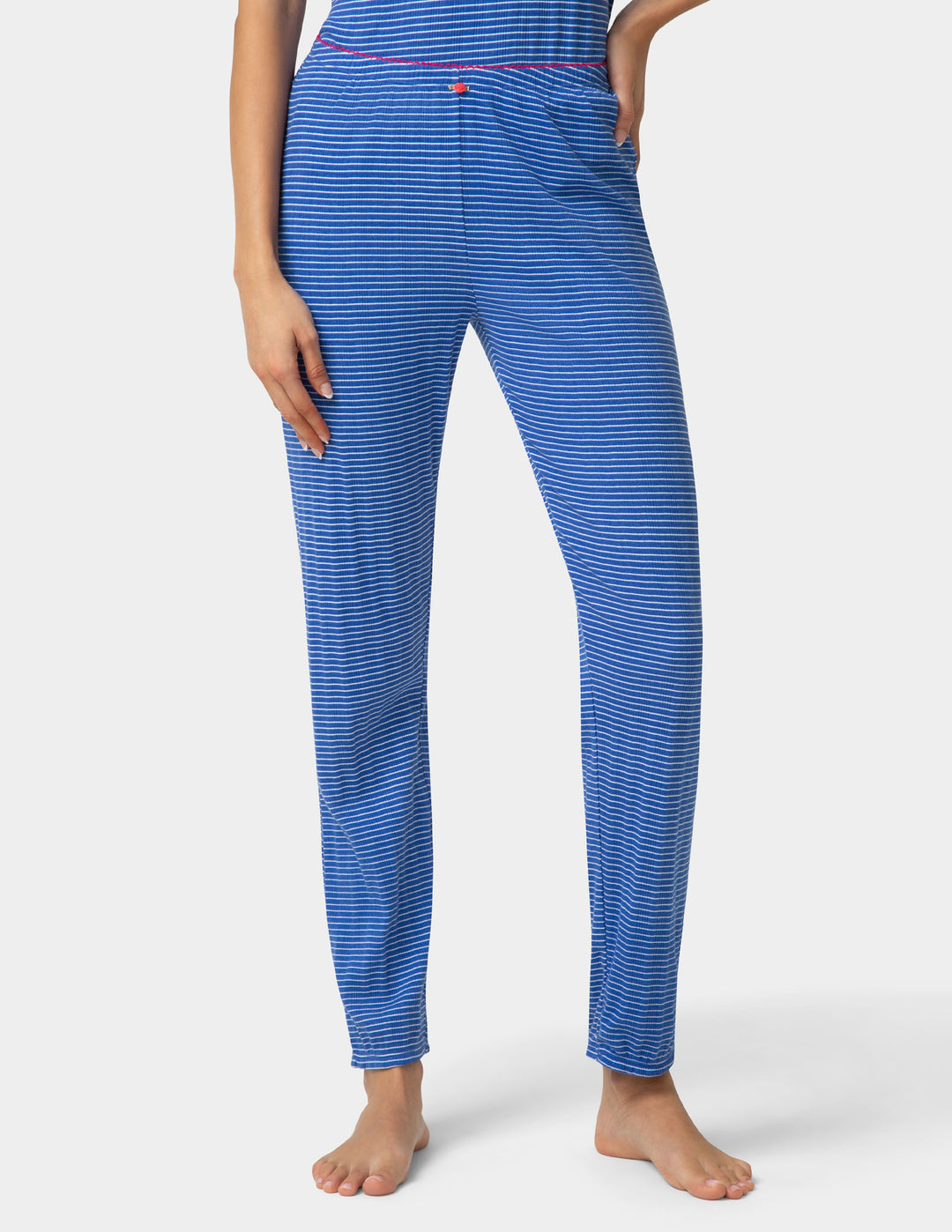 Woman wearing a blue striped pajama jogger on a white background