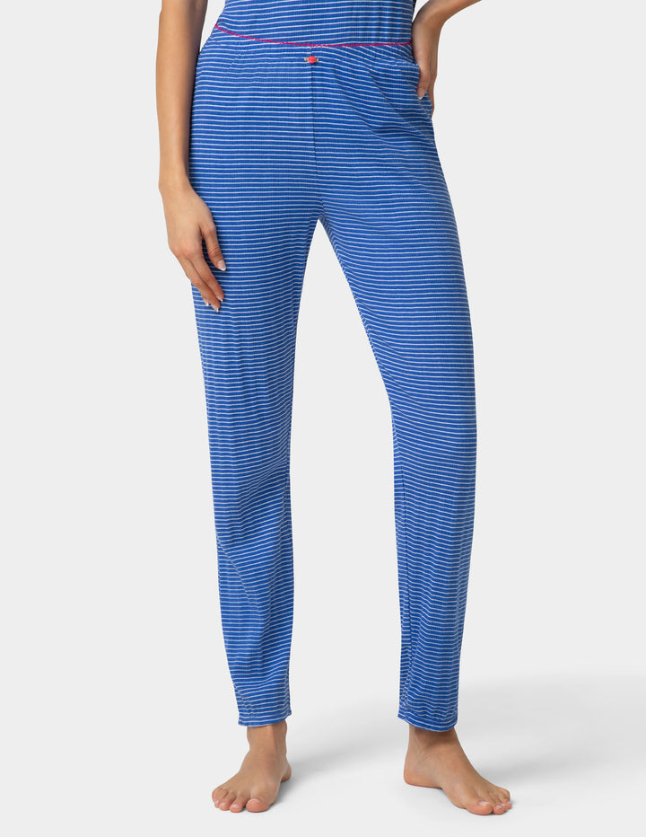 Woman wearing a blue striped pajama jogger on a white background