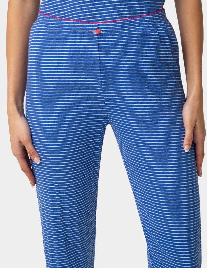 Blue striped pajama jogger closeup on a plain background