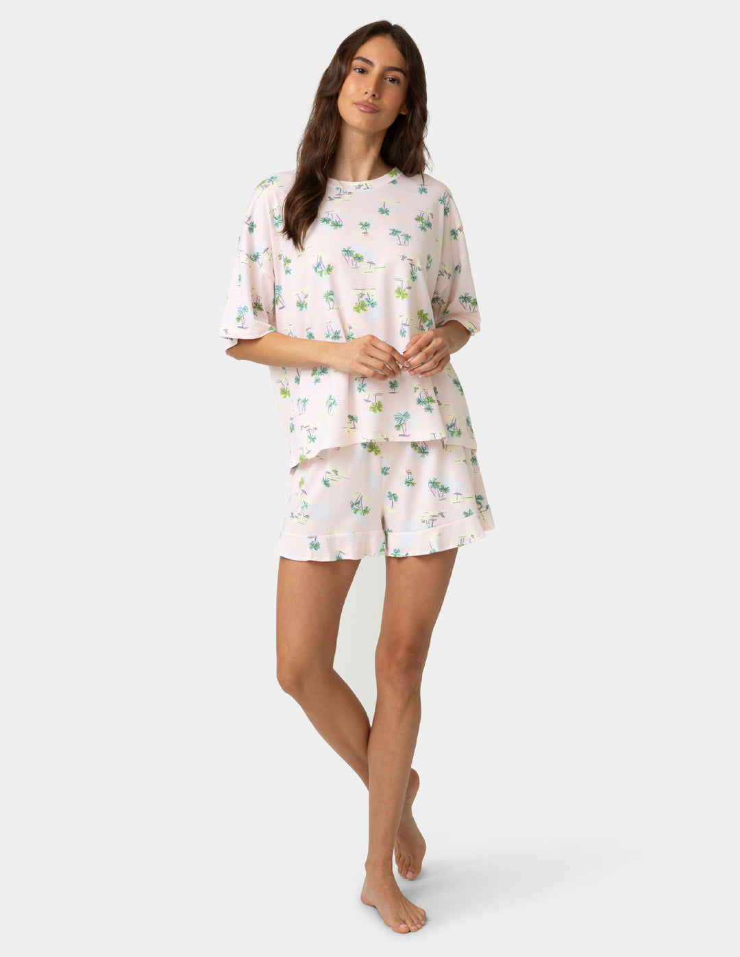Woman wearing a floral pajama set on a white background