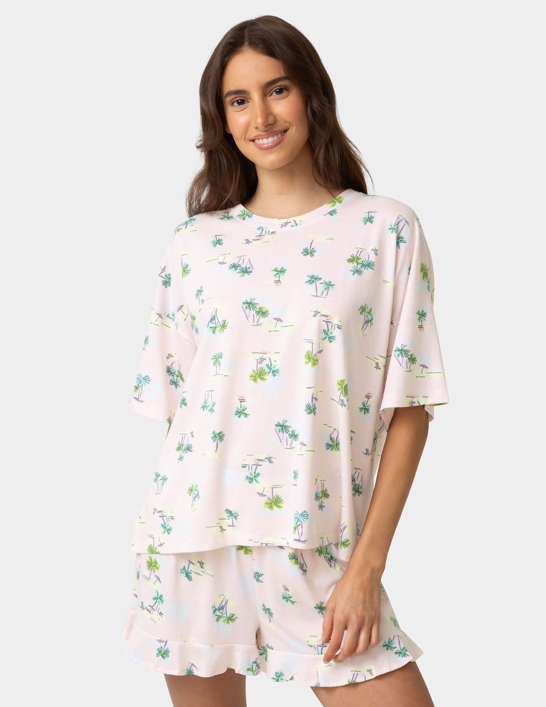 Woman wearing a floral pajama set on a white background