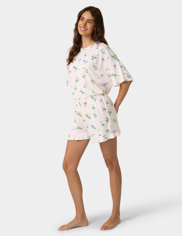 Woman wearing a floral pajama set on a white background