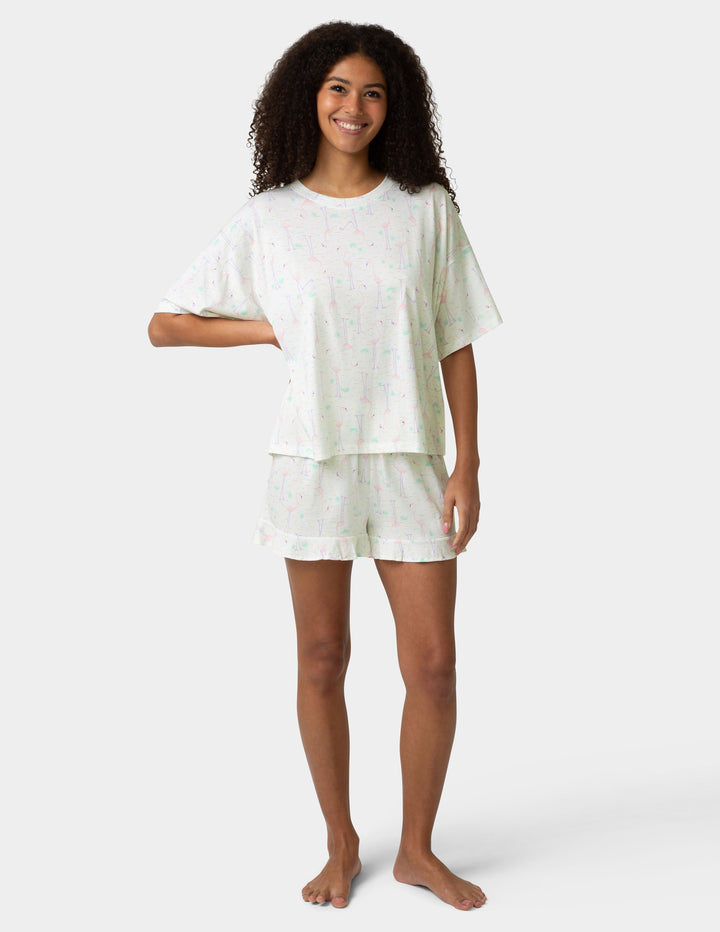 Woman wearing a white pajama set on a white background